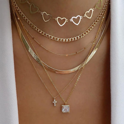 Layered necklace set featuring crystal pendants, rhinestones, chains, and charms