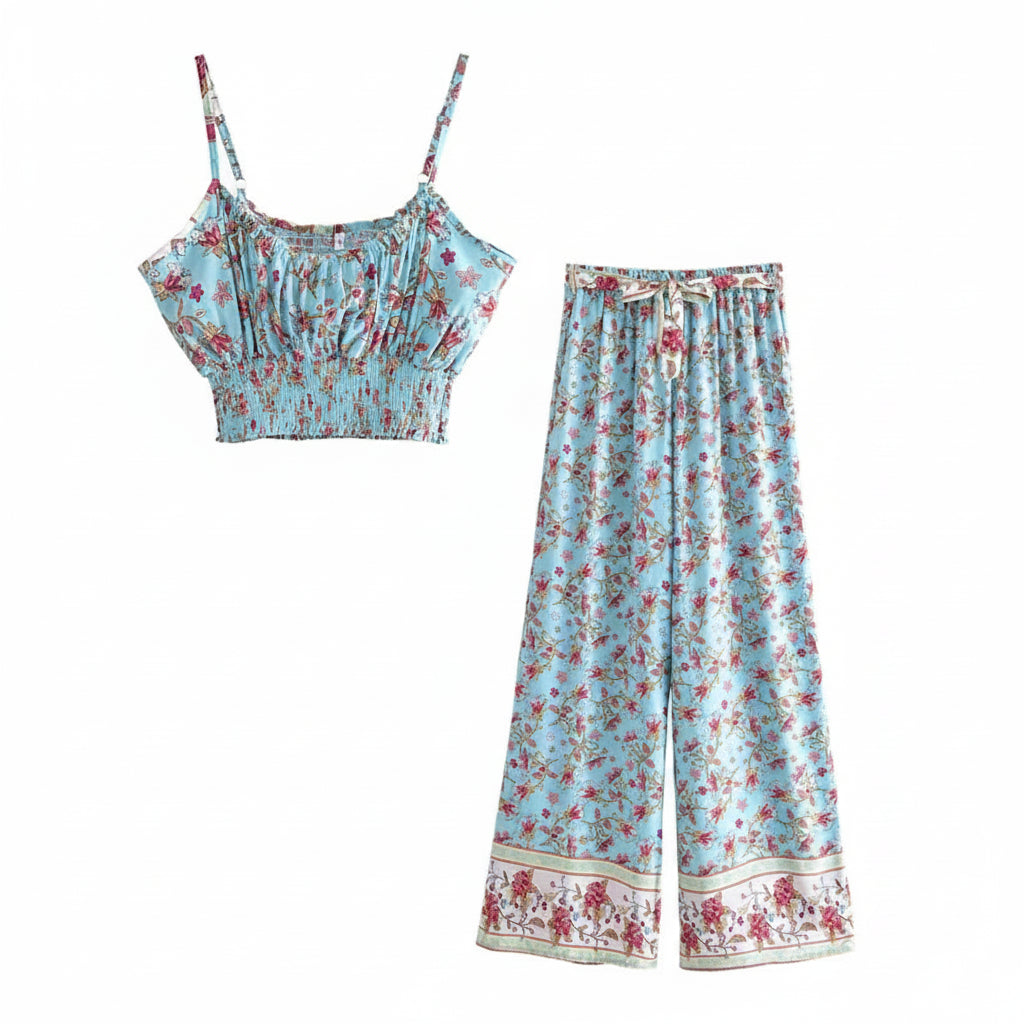 Blue floral flowy two-piece set featuring a smocked crop top and drawstring wide leg pants for a beach vacation.