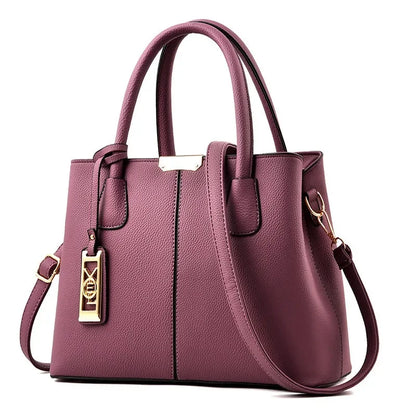Purple faux leather structured tote bag with zip closure and adjustable strap for everyday use.