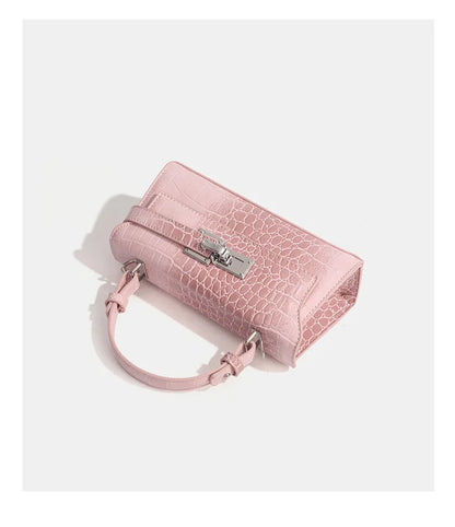 Pink faux leather structured crossbody bag with a metal latch for daily errands.