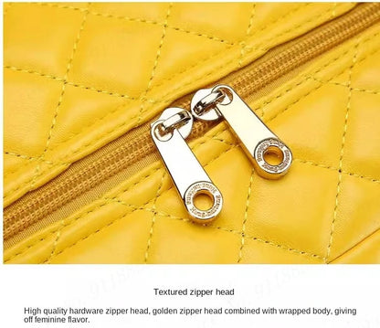 Yellow quilted PU suitcase with gold dual zipper pulls and stitching details.