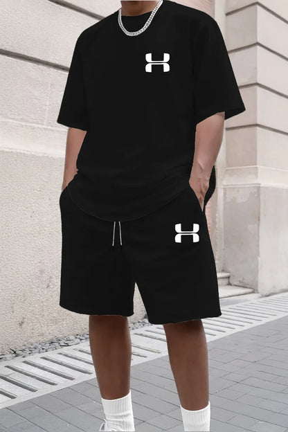 Black knit short sleeve tee and matching shorts set with a relaxed fit for athletic activities.