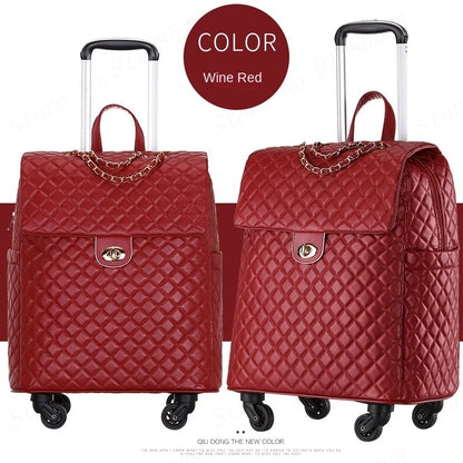 Wine red quilted PU leather rolling suitcase with gold chain accent and lock.