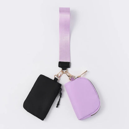 Black and purple nylon dual pouch wristlet wallet with zip closure for holding cards and coins on the go.