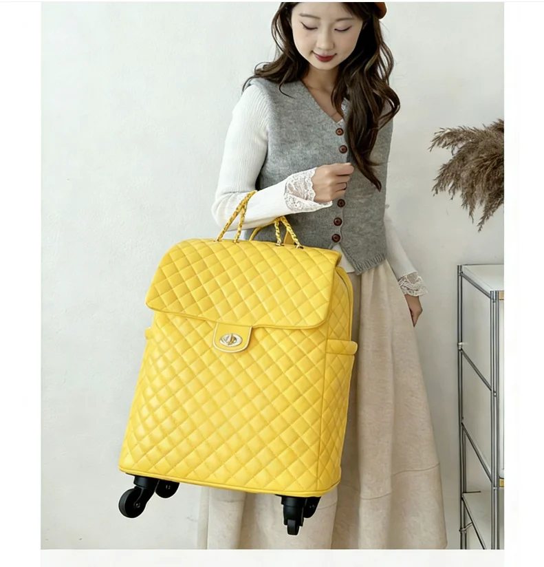 Bright yellow quilted leather wheeled travel bag with a flap closure, twist lock, and chain handles.
