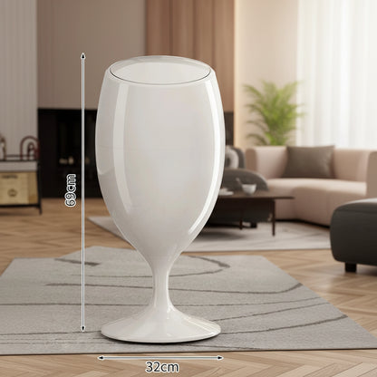 White wine glass-shaped trash can with dimensions, 69cm tall and 32cm wide, on a rug.