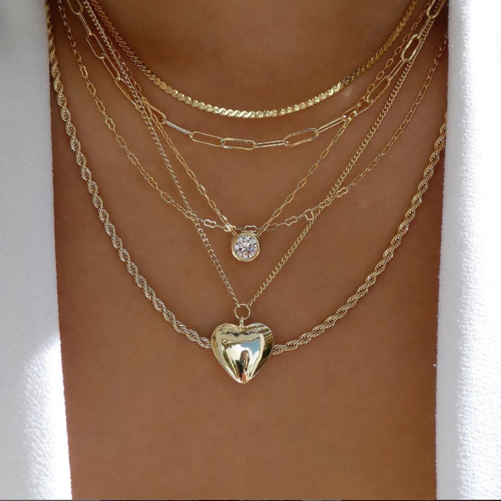 layered crystal pendant necklace set with rhinestones featuring multiple chains and heart charm