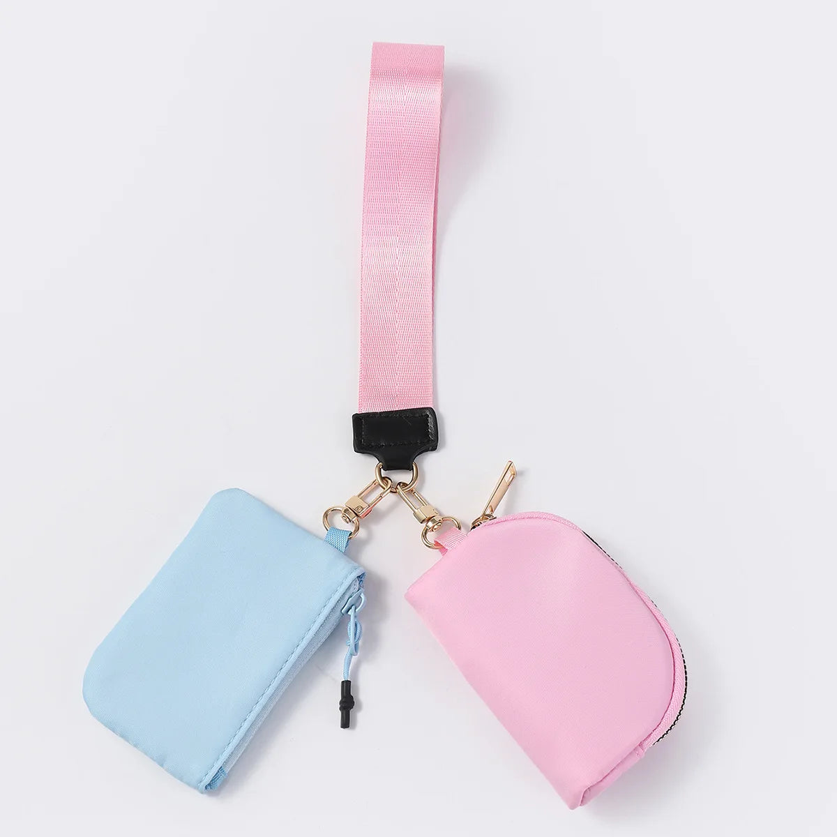 Blue and pink nylon dual pouch wristlet with zip closure for holding cards and coins on the go.