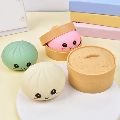 Soft silicone dumpling fidget toy with colorful faces and mini steamer baskets for stress relief play.