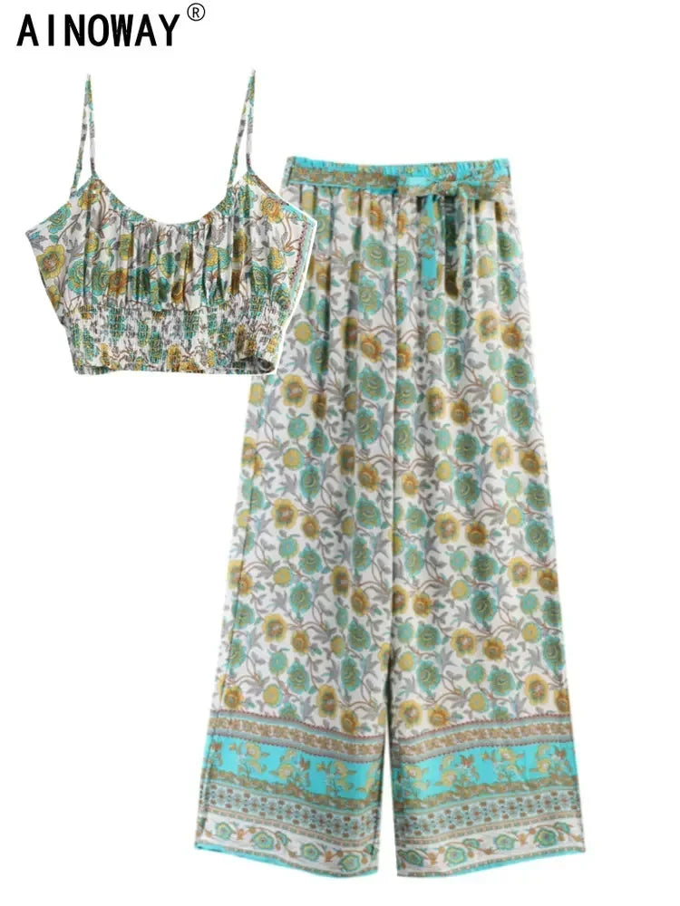 White floral print two-piece set with flowy wide leg pants and a smocked crop top for summer beach vacations.
