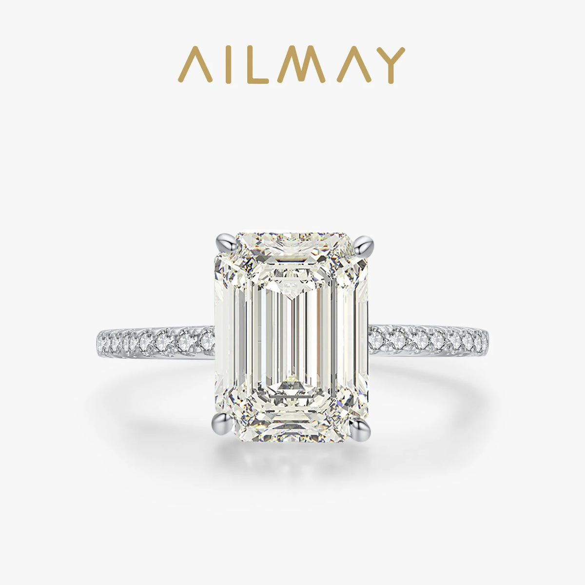 Silver sterling ring featuring a large emerald-cut rectangular stone and a pavé-set band of smaller stones.