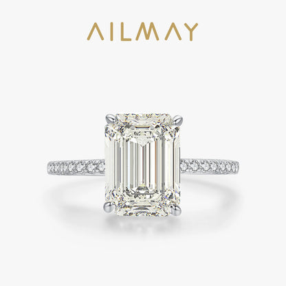Silver sterling ring featuring a large emerald-cut rectangular stone and a pavé-set band of smaller stones.