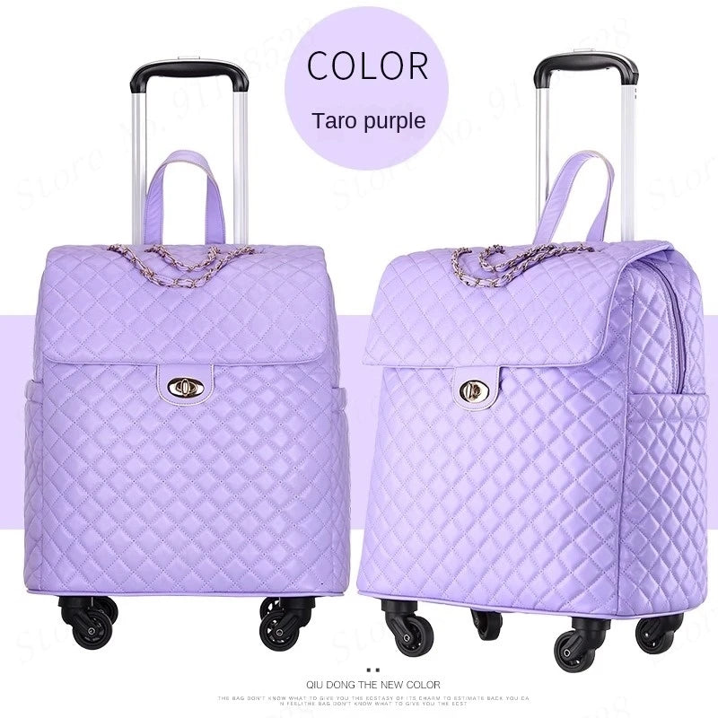 Taro purple quilted PU retro rolling luggage with a top handle, turn-lock flap, chain detail, and wheels.