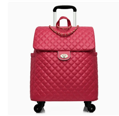 Hot pink quilted rolling luggage with gold-tone hardware, a top handle, turn-lock closure, and retractable handle.