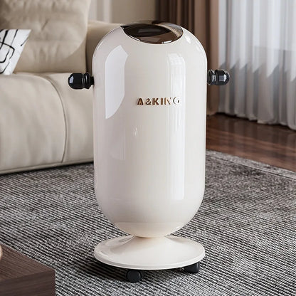 Glossy cream-colored cylindrical trash can with black side handles, gold lettering, and wheels on a rug.