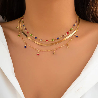 Layered necklace set featuring multi-strand chains with crystal pendants and rhinestones