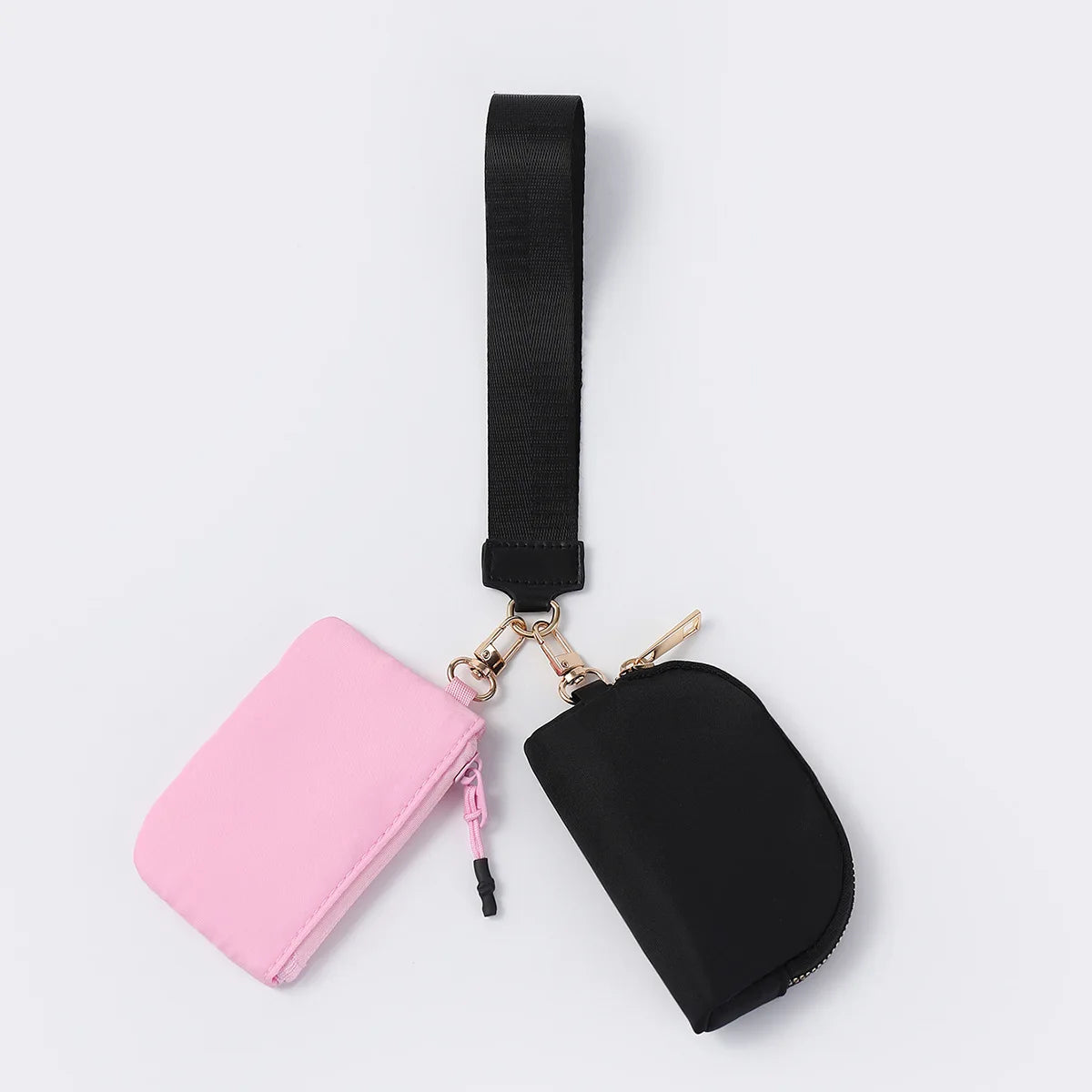 Black and pink nylon dual pouch with zip closure and adjustable strap for carrying cards and keys while traveling.