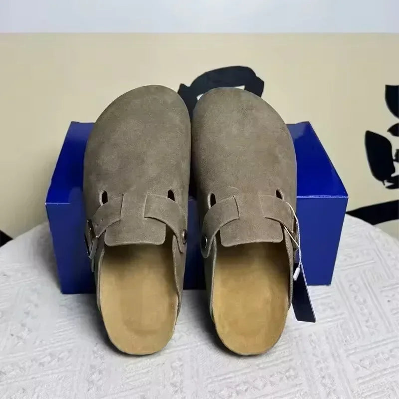 Taupe suede slip-on non-slip mules with buckle detail for beach wear.