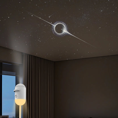 White portable LED galaxy projector displays a black hole and stars on a bedroom ceiling for a relaxing environment.