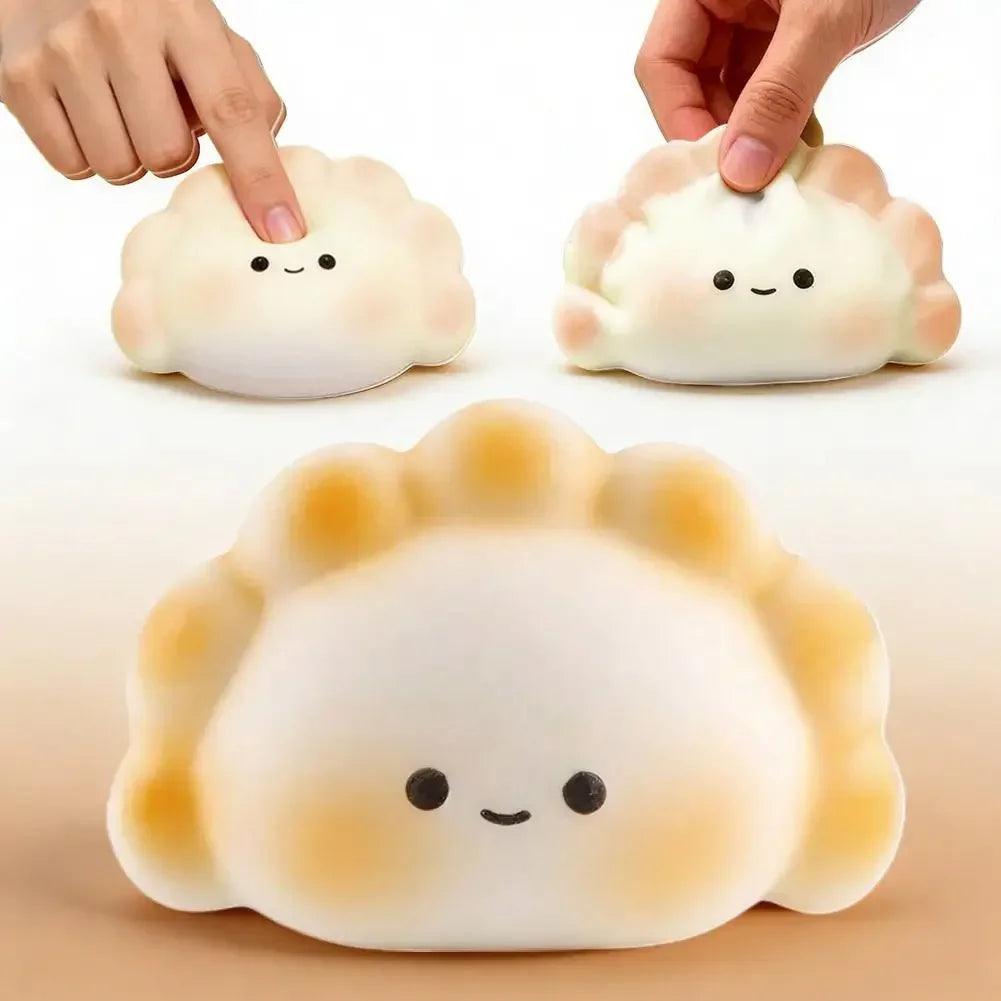 White, soft dumpling squishy fidget toy with a smiling face for portable stress relief and sensory play.
