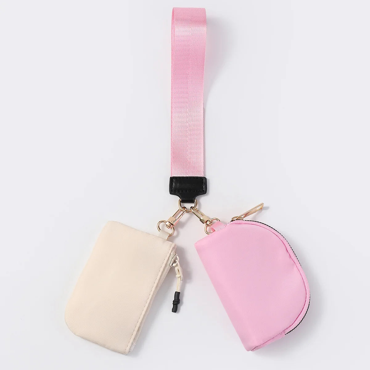 Pink and beige nylon multi-pocket wristlet wallet with zip closure for holding cards, coins, and keys on the go.