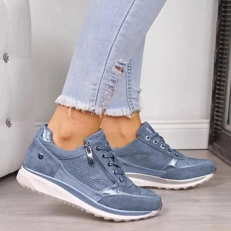 Blue faux suede wedge sneakers with side zippers and metallic accents for casual daily wear.