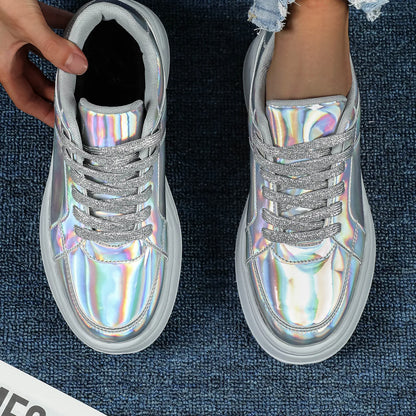 Holographic silver casual sneakers with thick white soles and sparkly silver laces.