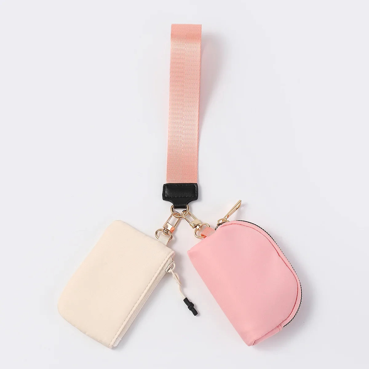 Pink and cream nylon dual pouch wristlet wallet with a zip closure for carrying cards and keys while on the go.