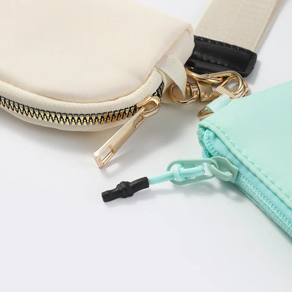 Cream and mint nylon dual pouch with zip closure and gold hardware for daily essentials.