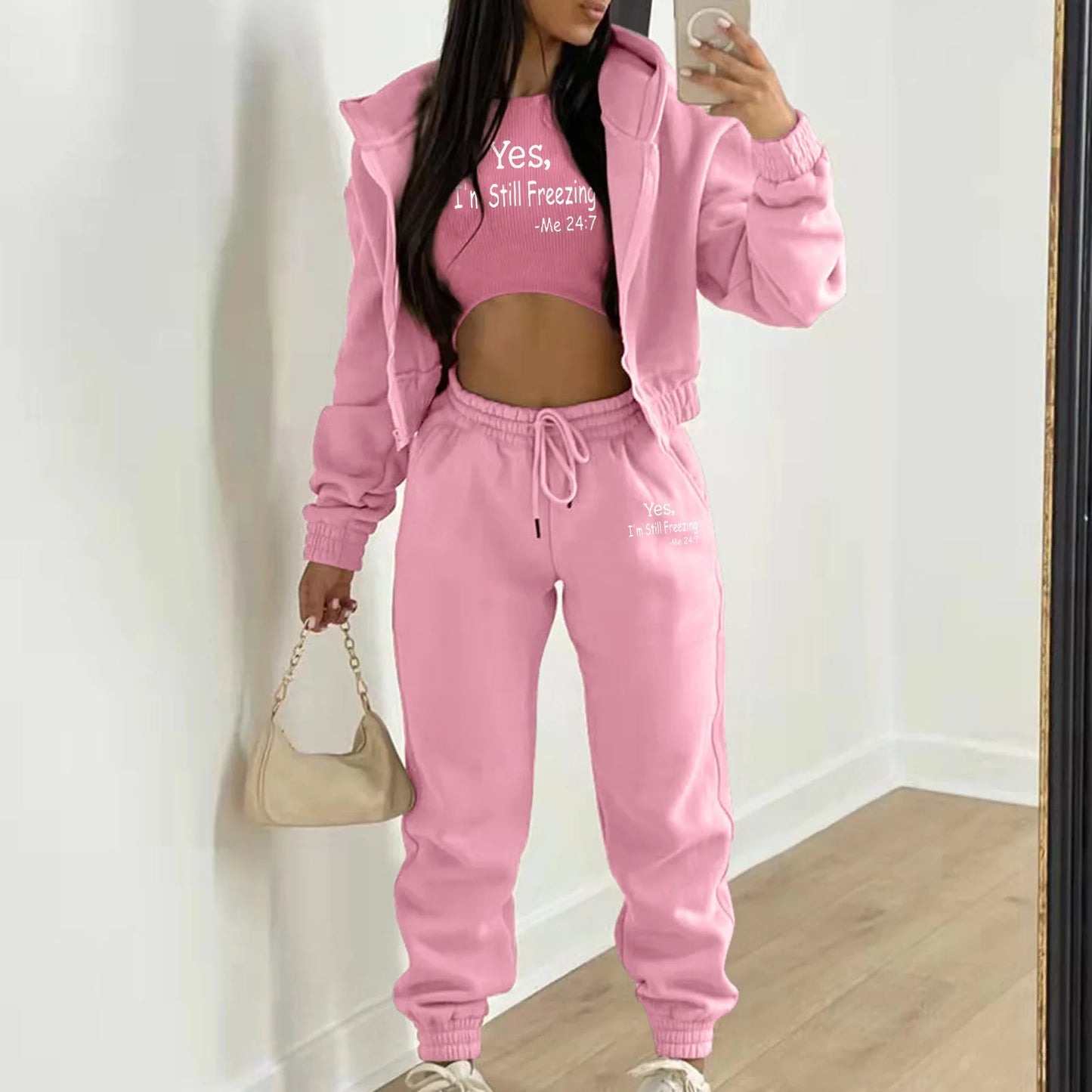 Pink hooded knit sweater set with white letter print and high waist joggers for a relaxed loungewear outfit.
