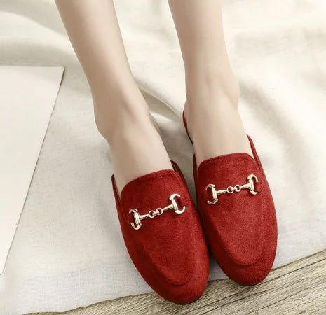 Red suede slip-on mules with a gold metal chain detail for outdoor wear.