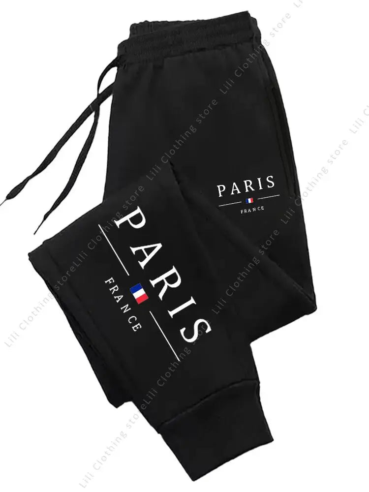 Black fleece-lined jogger pants with Paris France print and drawstring waist, designed for comfortable lounge wear.