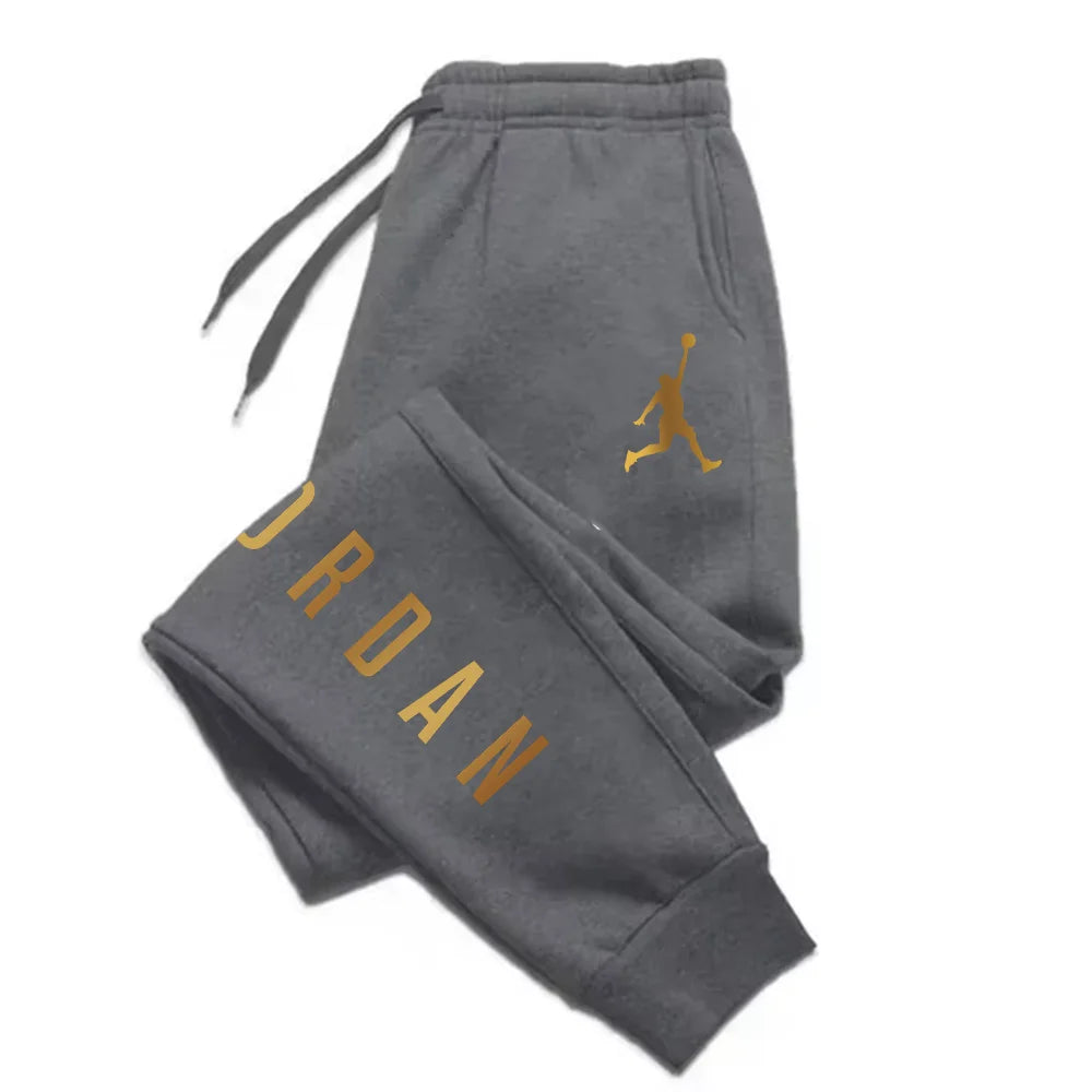Grey midweight joggers with gold letter print and drawstring waist, fitted for daily athletic training.
