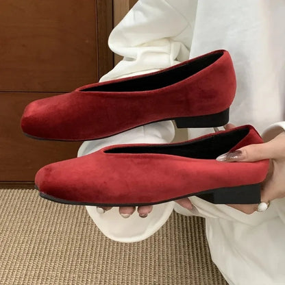 Deep red suede slip-on flats with a square toe and black heel for comfortable daily wear.