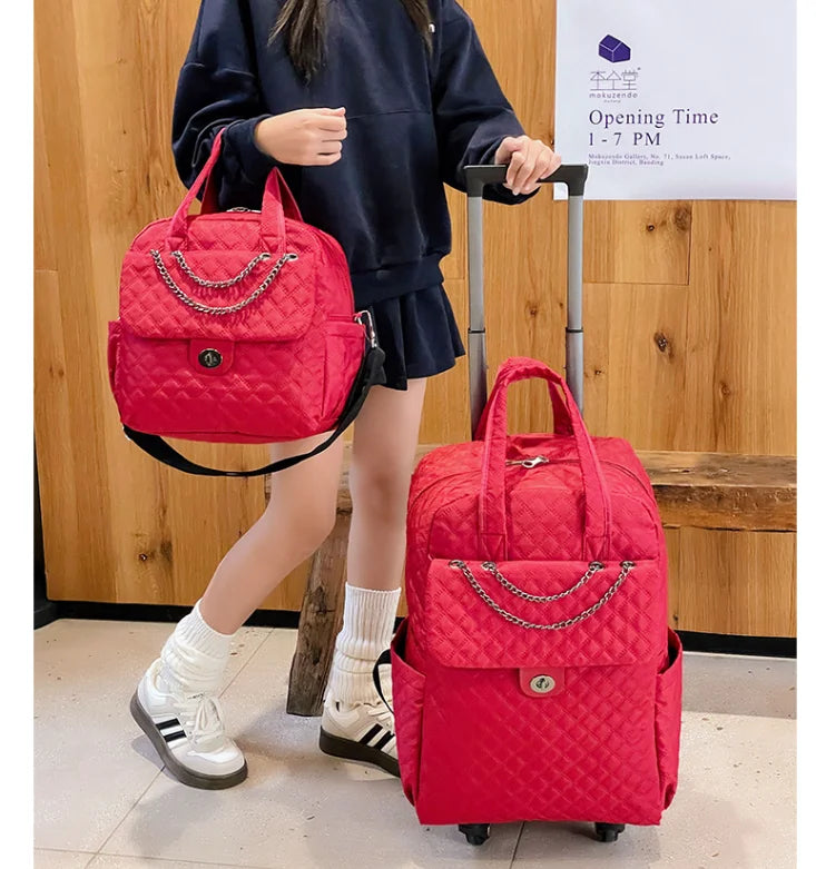 Red quilted nylon rolling luggage bag with chain detail, top handles, and retractable handle.