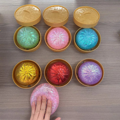 Colorful, glittery dumpling squishy fidget toys in mini bamboo steamer pots for sensory stress relief.