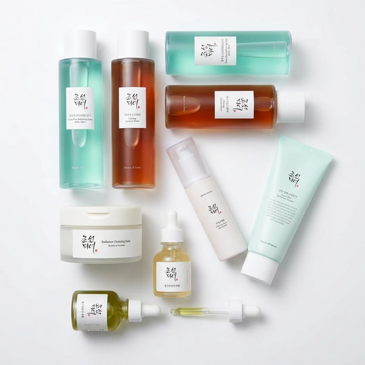 Skincare set featuring bottles of toners, essences, dropper serums, a pump bottle, a cream jar, and a tube.