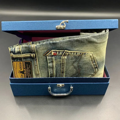 Faded blue stretch denim tapered jeans with a leather label in a blue box for daily wear.