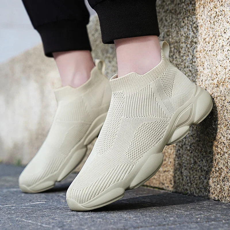 Beige knit slip-on sneakers with a cushioned sole and breathable design for daily wear.