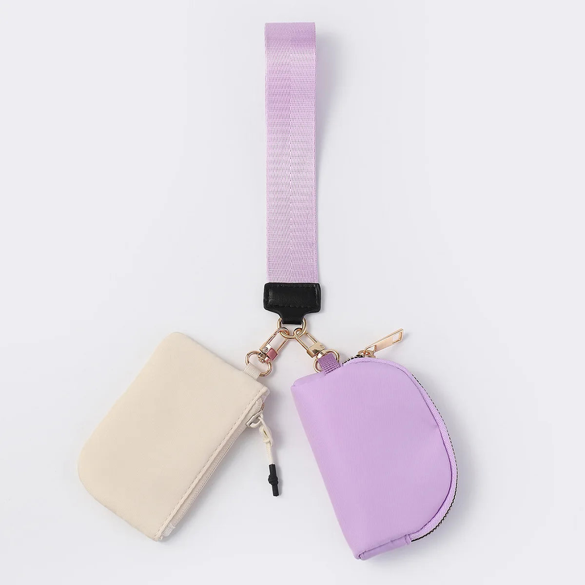 Lavender and cream nylon waterproof wristlet wallet with zip closure and adjustable strap for everyday carry.