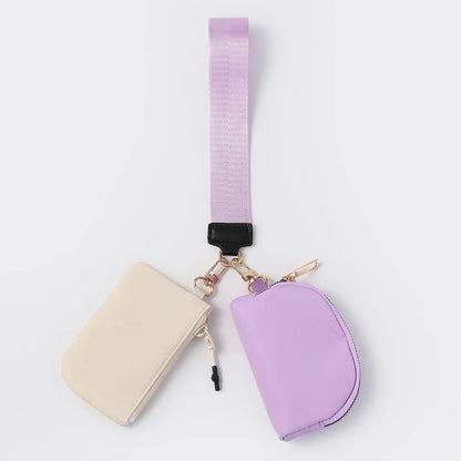 Lavender and cream nylon waterproof wristlet wallet with zip closure and adjustable strap for everyday carry.