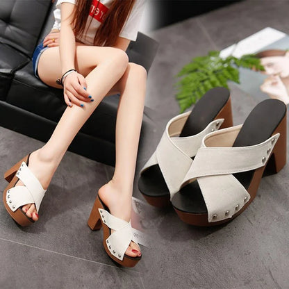White flock platform sandals with rivet details and brown heels as slip-on shoes for casual summer outfits.