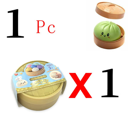 Green silicone dumpling toy with cute face in a brown plastic steamer box as a mystery collectible fidget toy.
