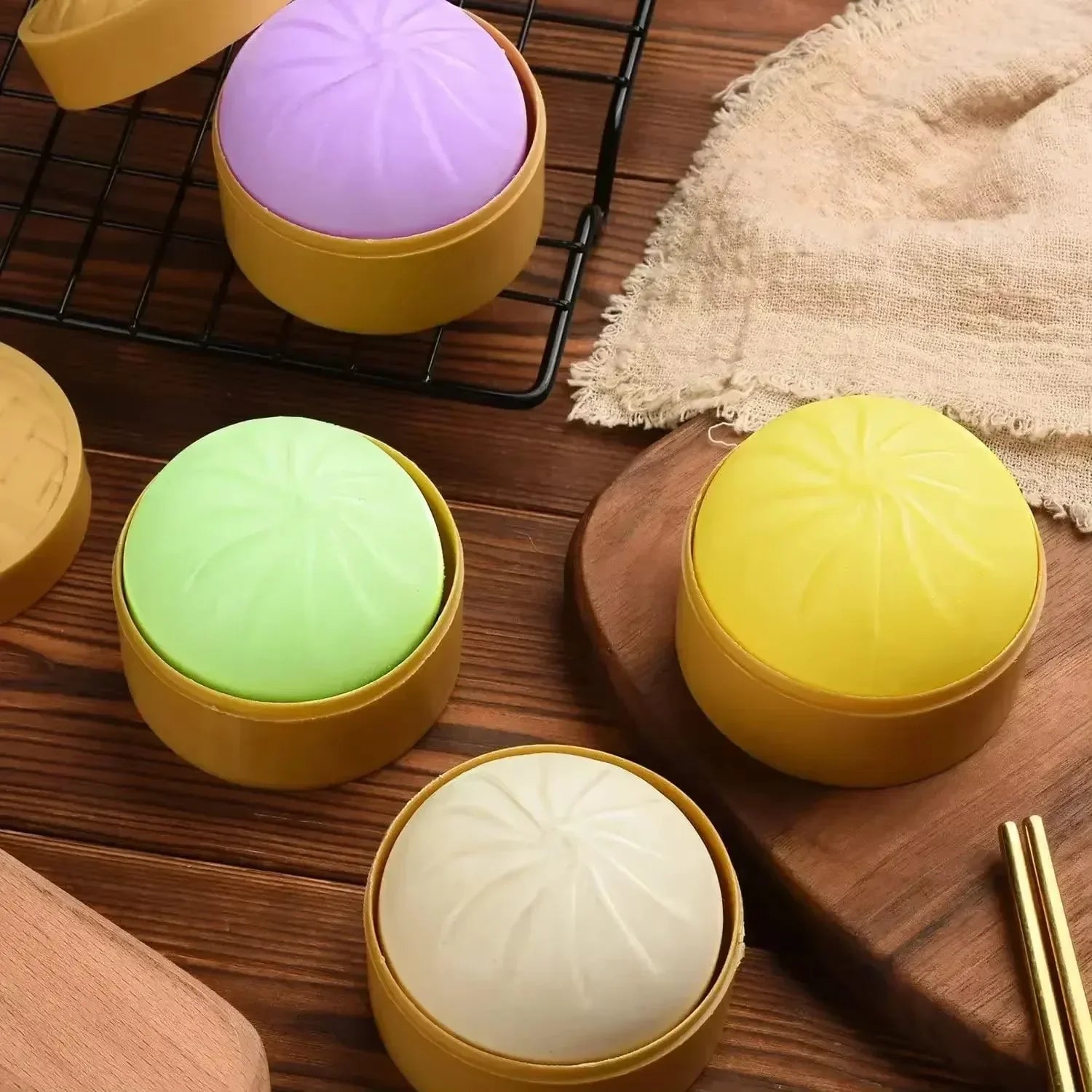 Colorful silicone squishy fidget toy set with dumpling buns in a steamer basket for stress relief.