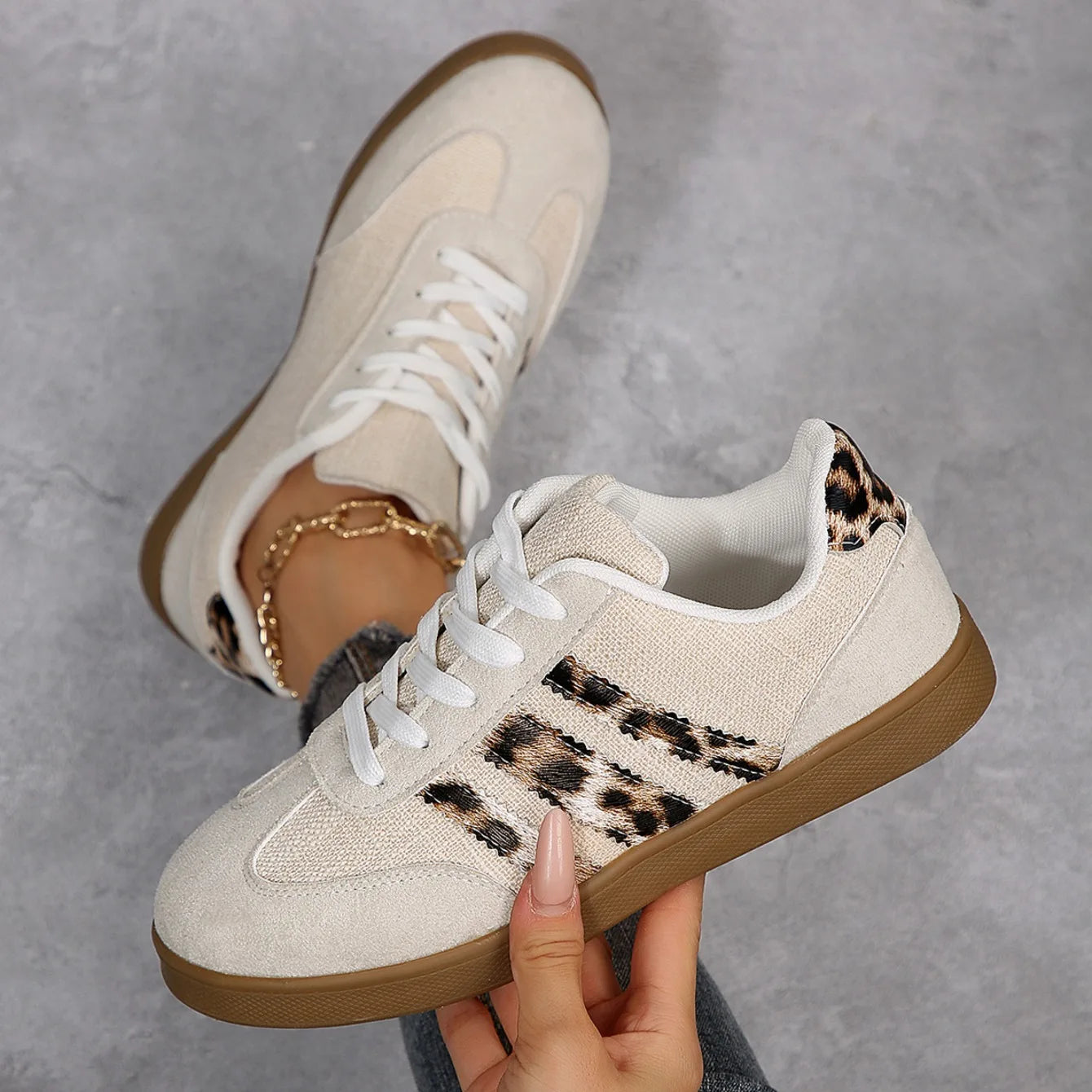 Beige lace-up sneakers with leopard print detail and cushioned soles for comfortable outdoor walking.
