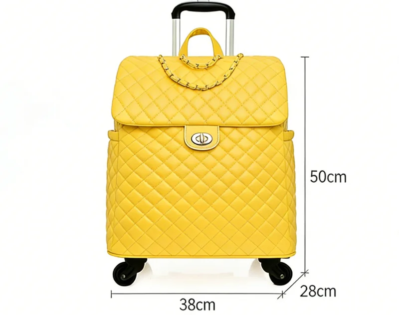 Yellow quilted leather rolling travel suitcase with a chain detail, top handle, and extendable trolley handle.