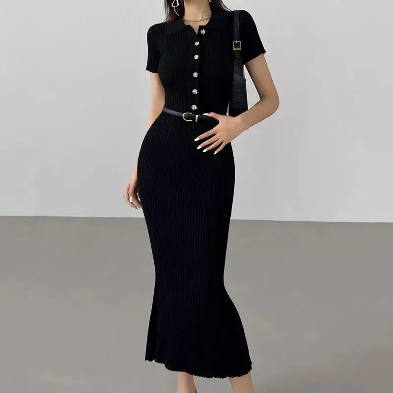 Black ribbed knit mermaid dress with a button-down bodice for resort wear.