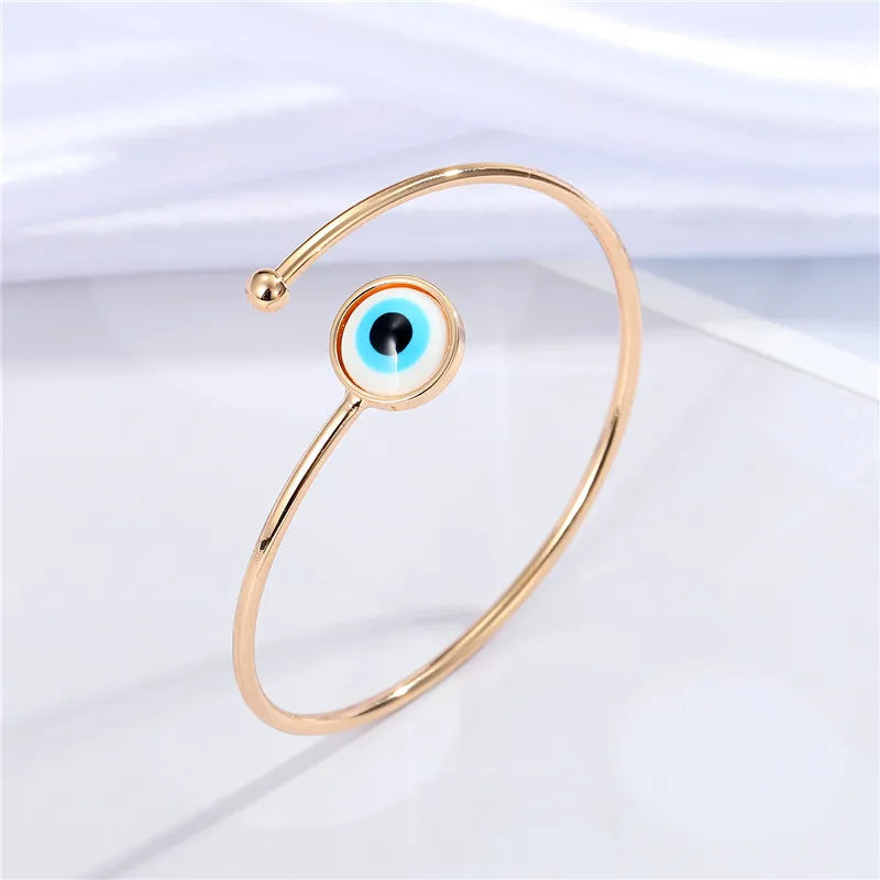 Adjustable cuff bracelet with a geometric evil eye motif
