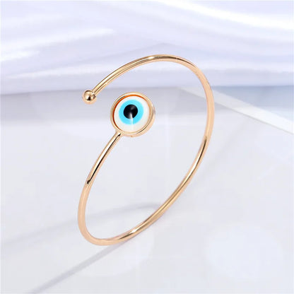 Adjustable cuff bracelet with a geometric evil eye motif