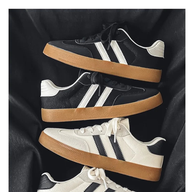Black and white canvas sneakers with breathable gum soles for casual training.